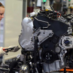 INGOLSTADT, GERMANY - MARCH 11:  An Audi employee works on an engine for an Audi A3 automobile, produced by Volkswagen AG's Audi brand, as the unit moves along the engine production line at the company's plant in Ingolstadt, Germany, on Monday, March 11, 2013. Audi is set to spend 13 billion euros ($17 billion) through 2016 to expand and develop new cars pursuing BMW?s sales lead.